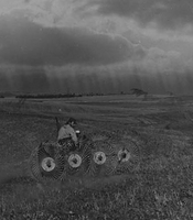 Raking hay with oncoming storm in northern Negev, Israel, 1970